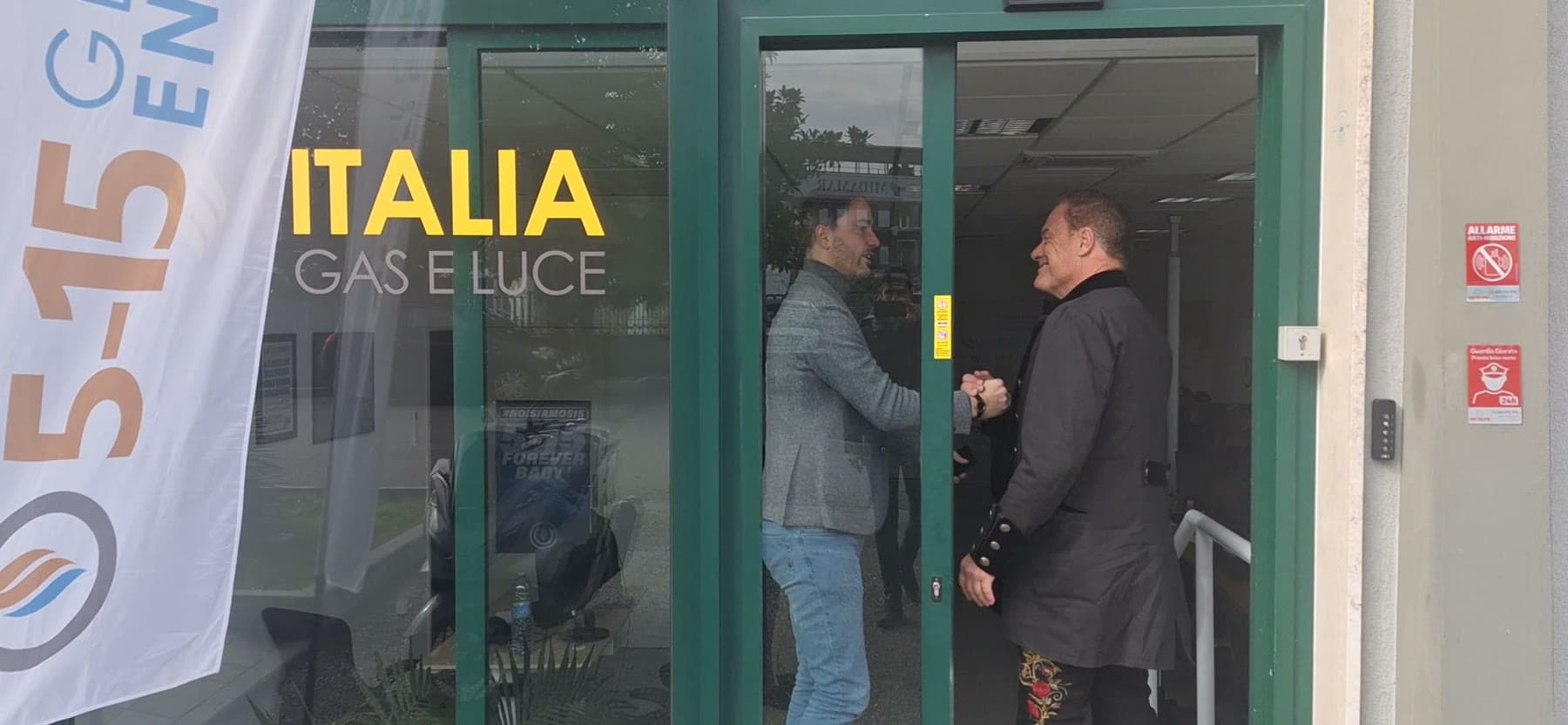 Tom Cummins shaking hands at the office door on arrival.