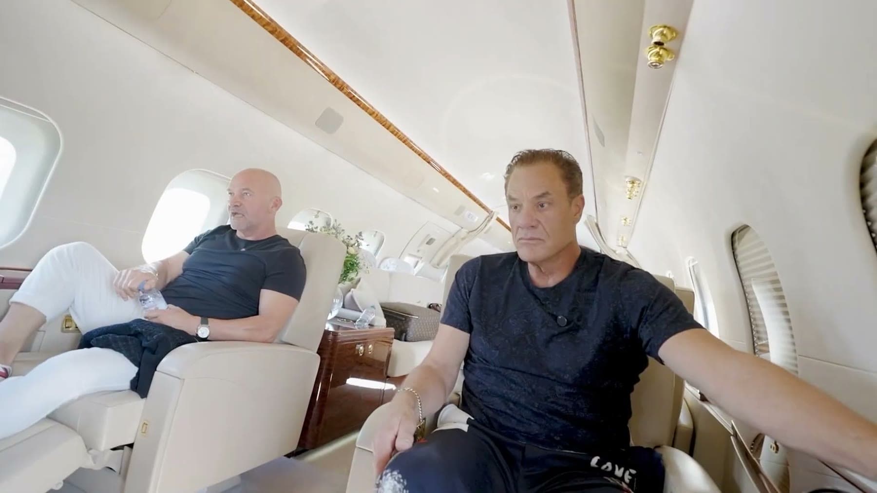 Tom Cummins in conversation with his longtime business partner in a jet cabin.