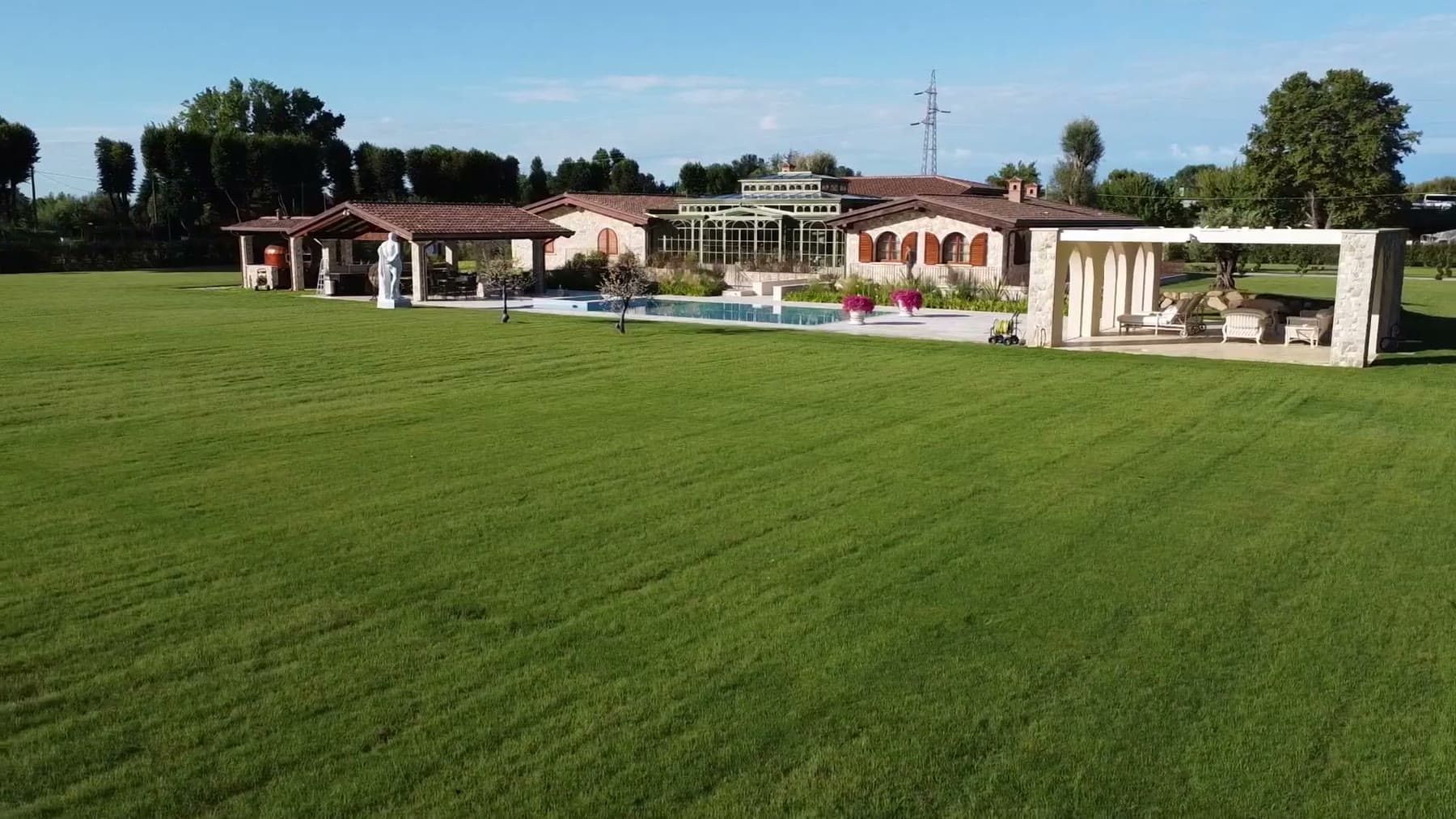 Aerial view of Tom Cummins's finished estate with lawn and pool.