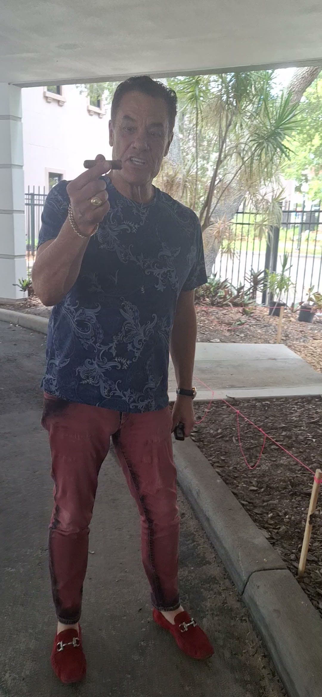 Tom making a point, cigar in hand, outside the office