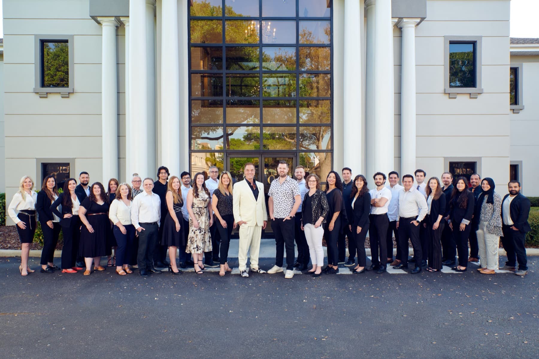 The Cummins Worldwide team, thirty-plus strong, in front of headquarters in Clearwater with Tom at the center