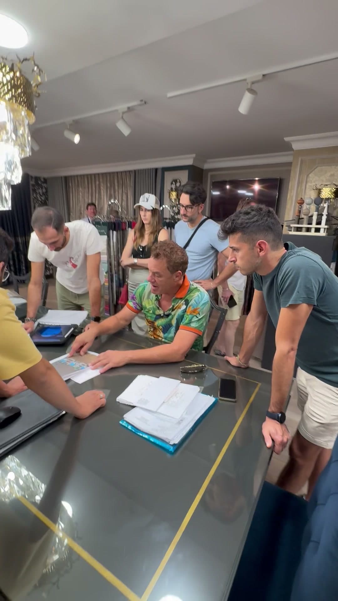 Tom holding court at a showroom table in Istanbul, the team leaning in