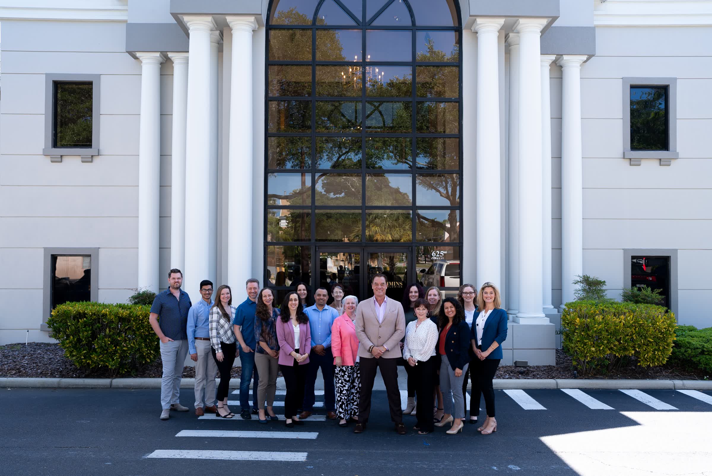 Tom Cummins with the whole team gathered outside headquarters.