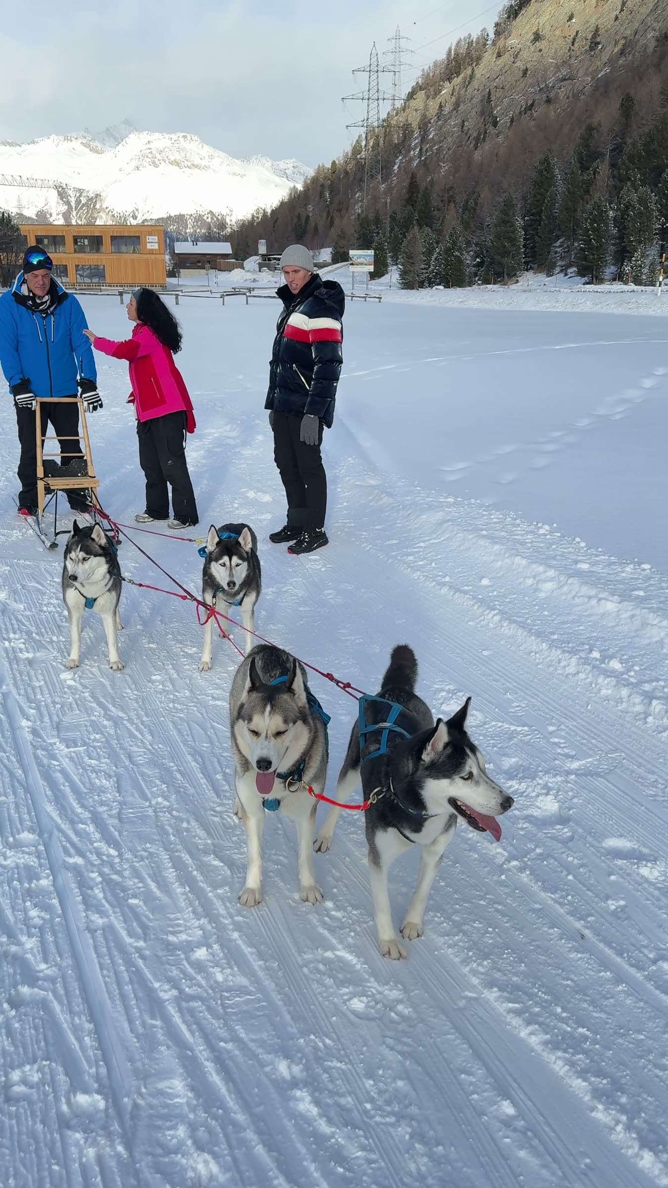 Tom and Victoria with guides and a husky sled team on the snow