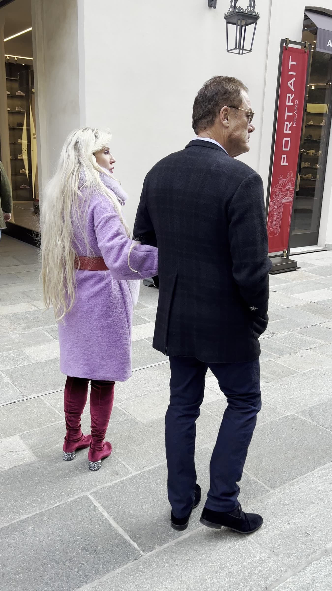 Tom and Victoria arm-in-arm through the boutique arcades of Milan