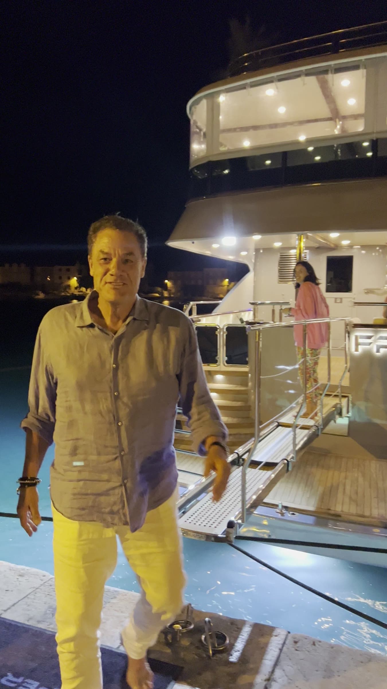 Tom on the dock at night as the group boards the yacht in Split