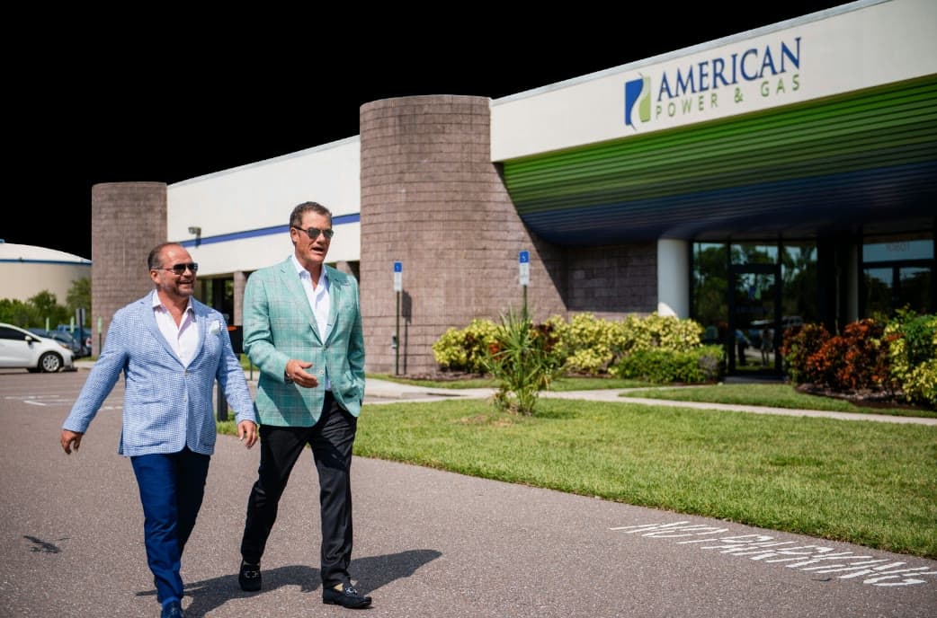 Tom Cummins and Jim Bridgeforth walking outside American Power & Gas headquarters