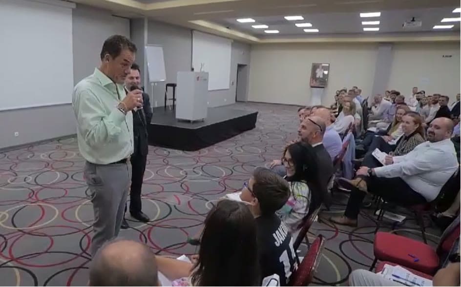 Tom Cummins taking questions from his team on the seminar room floor.